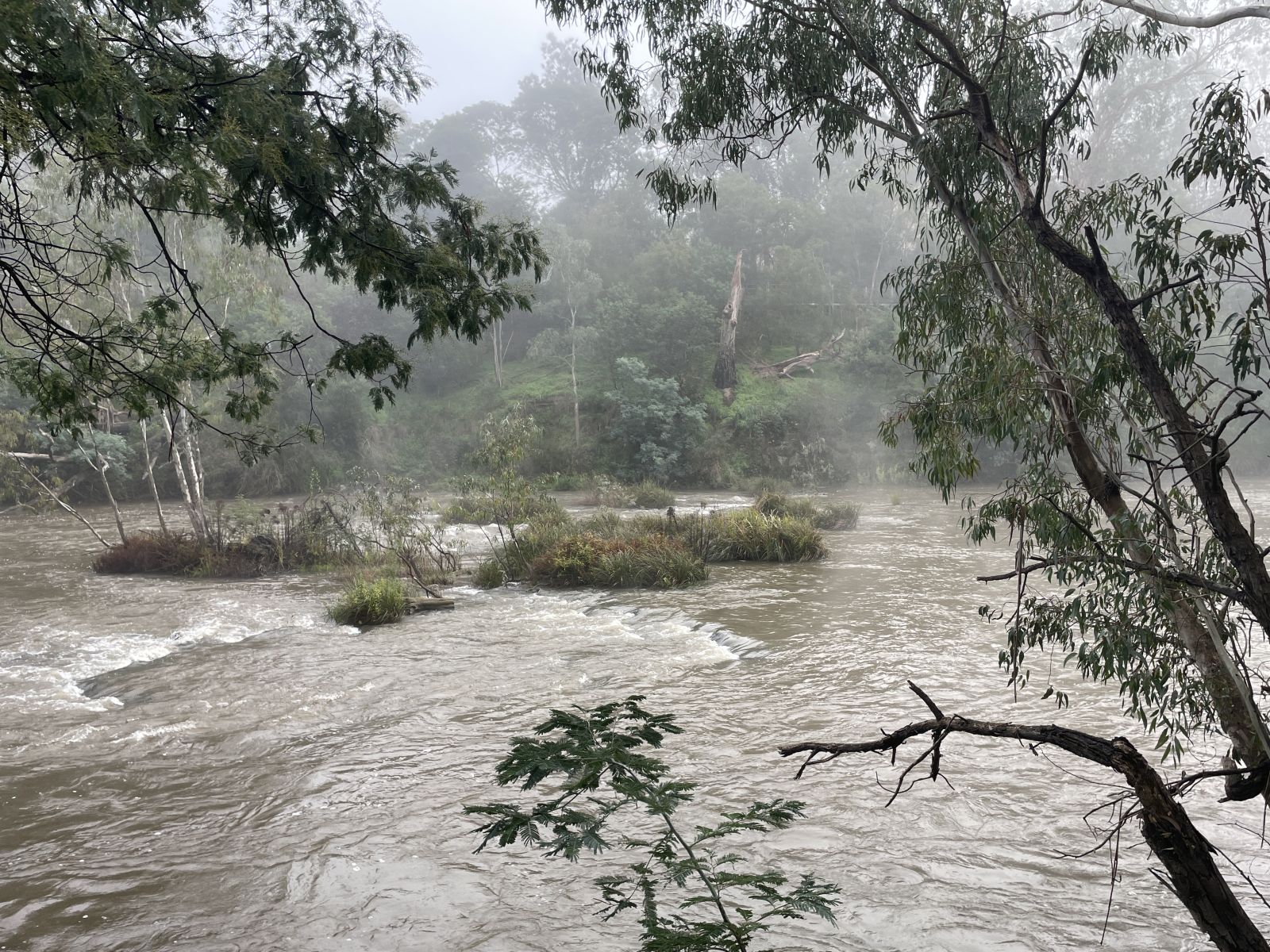 River flowing fast with mist over the water